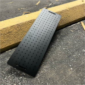 Hard-anodized black 6061 fixture plate for the Millennium Mills Milo CNC mill — drilled 20 mm workholding hole grid with mounting slots
